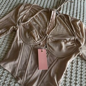 Miss Lola corset top in nude/tan color.
